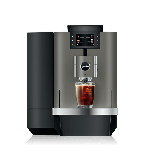 Front view of OBM3 coffee machine brewing iced coffee with touchscreen display and glass cup on a white background