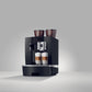 OBL2 Giga X8C Black coffee machine with two cups of coffee on a gray background