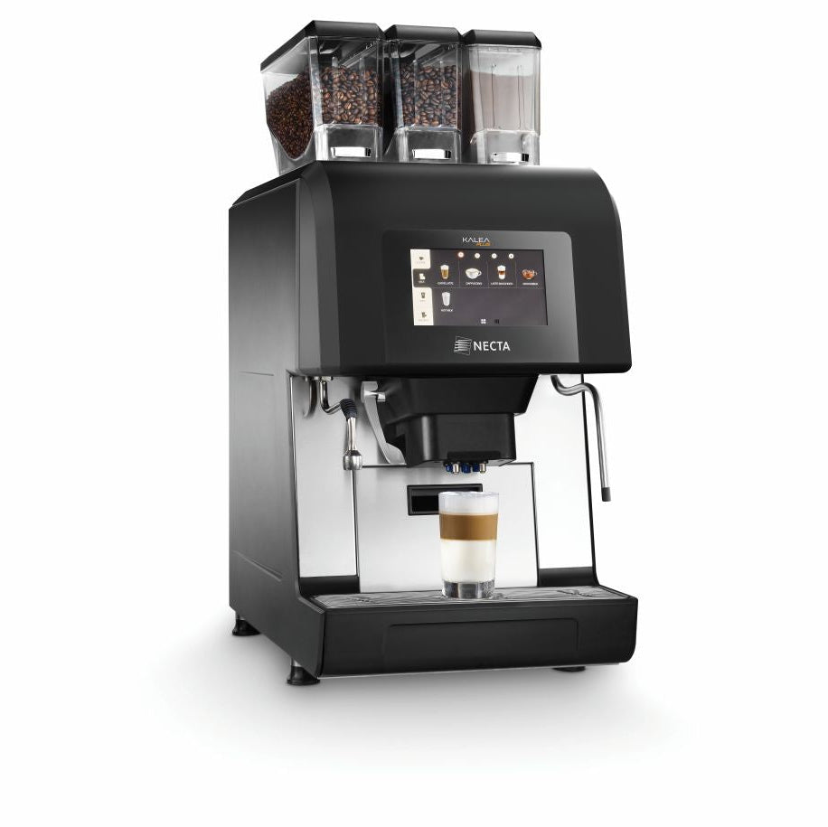 Angled view of OBL3 Necta Kalea Plus coffee machine with three bean hoppers and steaming wand preparing a layered latte on a white background