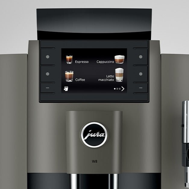 Close-up detail of OBS1 coffee machine digital display and Jura logo on a gray background