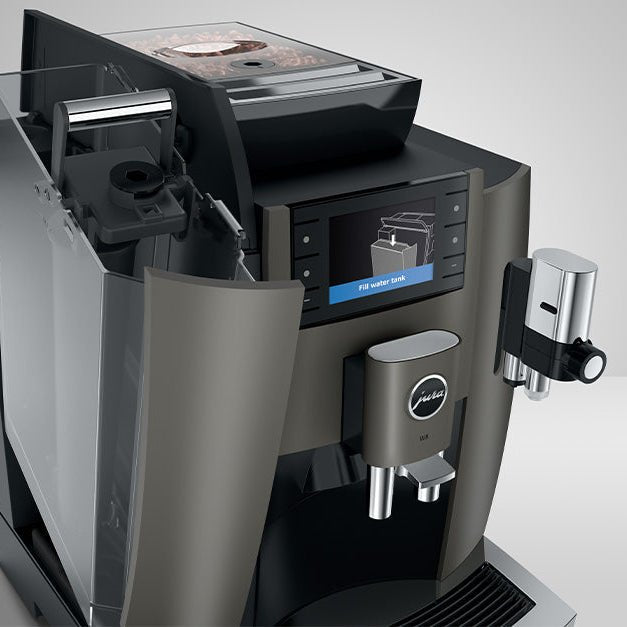 Angled view of OBS1 coffee machine with digital display showing water tank open, highlighting removable reservoir and steam wand on a white background