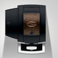 Top view of OBS3 Jura X10 coffee machine with open bean hopper filled with coffee beans, featuring sleek black design and silver finish on a light background