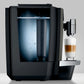 Side view of OBS3 Jura X10 coffee machine with clear water tank and a glass cup of coffee on a white background