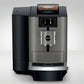 OBM3 Jura X10 coffee machine with bean hopper on top and digital display, shown on a light gray background