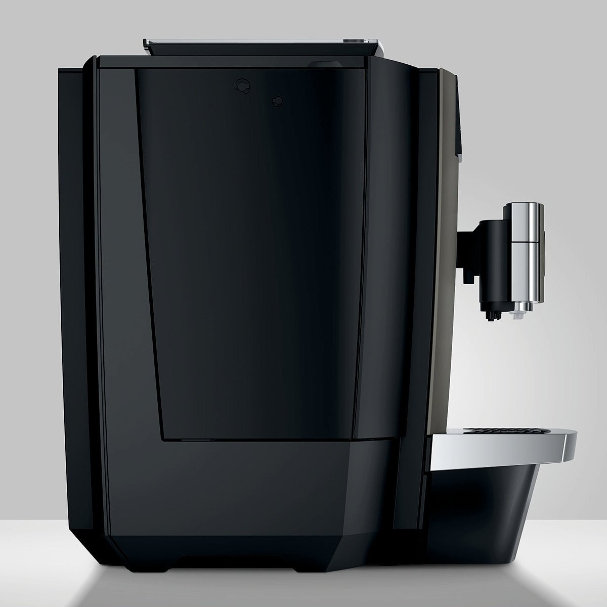 Left side view of OBM3  Jura X10 coffee machine with sleek black casing and milk spout, on a light gray background