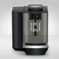 Front view of OBS3 Jura X10 coffee machine with digital display and brew dispenser on a light gray background